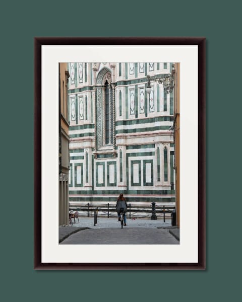 A photo of a Girl in Florence riding a bicycle towards the Duomo in Florence, Italy taken by Photographer Scott Allen Wilson.