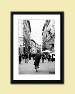 Photo of a girl in Florence, Italy riding a bicycle near piazza della repubblica by Photographer Scott Allen Wilson.