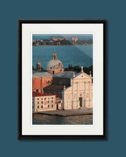A photo of two priests walking side-by-side in front of a venetian building in Venice, Italy. Artistic framed photograph taken by Photographer Scott Allen Wilson