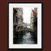 Beautiful photo taken in Venice, Italy by Photographer Scott Allen Wilson, of a narrow waterway and its bridges.