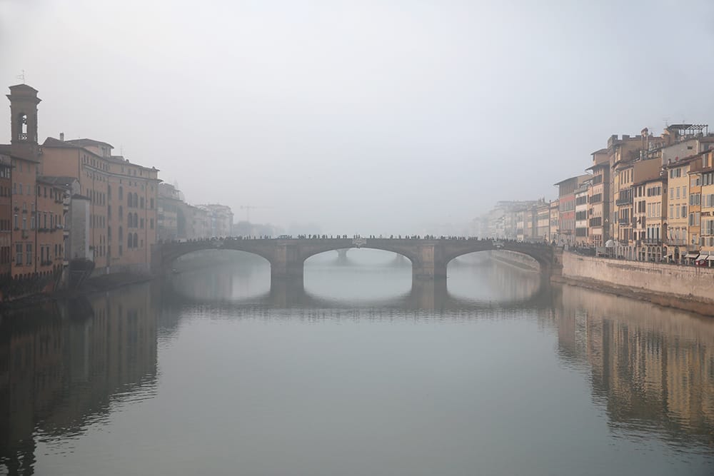 Ponte Santa Trinita in Florence, Italy taken in the midst of a dense fog by Photographer Scott Allen Wilson.
