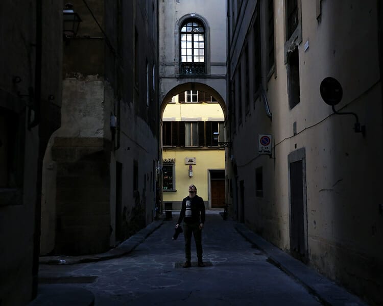 Portrait of Scott Allen Wilson looking up into the light in Florence, Italy
