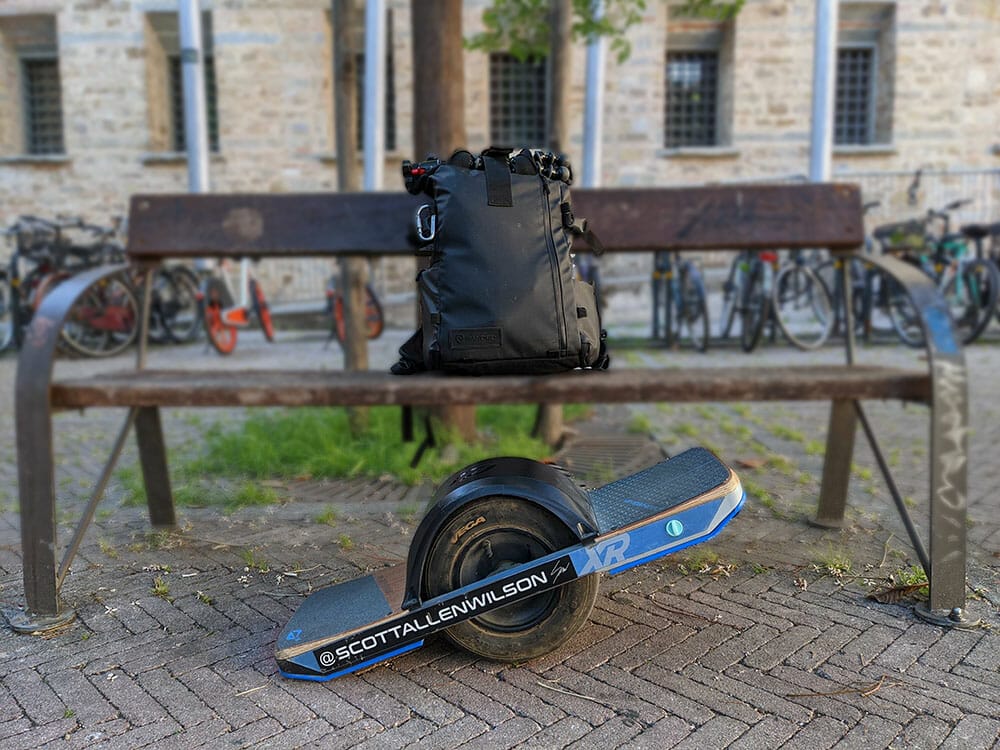 Photo of photographer, Scott Allen Wilson's onewheel XR and photography gear-filled backpack.