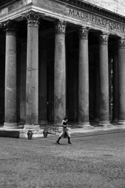 Black and white photography taken by Photographer Scott Allen Wilson in Rome, Italy, portrays a lady walking in front of the Pantheon.