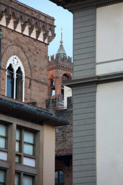 Shot taken of tower of Palazzo Vecchio between buildings in Piazza della Repubblica by Photographer Scott Allen Wilson.