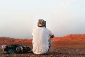 Portrait of photographer Scott Allen Wilson as he looks over the merzouga desert in Morocco.