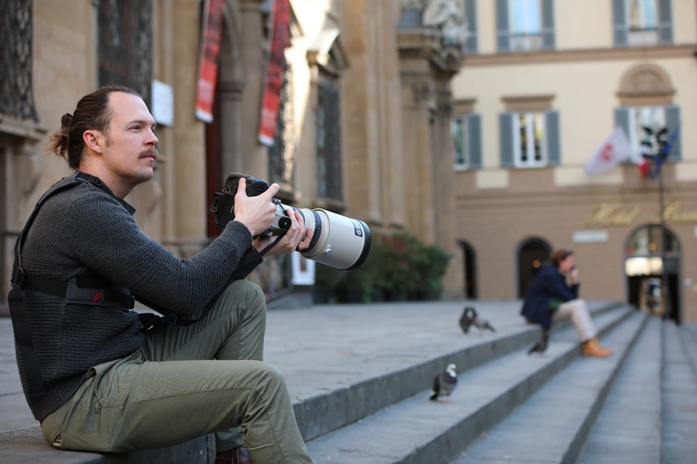 Portrait of Photographer Scott Allen Wilson, holding his camera in Piazza San Firenze in Florence, Italy