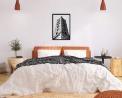 White and orange bedroom decoration with a framed print of the campanile of the Duomo di Siena taken by Photographer Scott Allen Wilson.