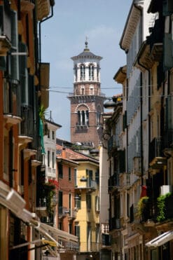 A narrow street in Verona, Italy captured by Photographer Scott Allen Wilson, who guides our view to the clocktower of Palazzo della Regione.