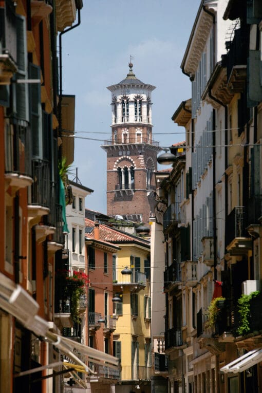 A narrow street in Verona, Italy captured by Photographer Scott Allen Wilson, who guides our view to the clocktower of Palazzo della Regione.