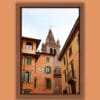 Artistic framed photo of Campanile of San Tommaso standing out between colorful buildings in Verona, Italy taken by Photographer Scott Allen Wilson