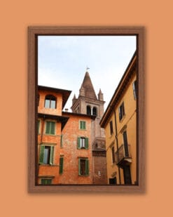 Artistic framed photo of Campanile of San Tommaso standing out between colorful buildings in Verona, Italy taken by Photographer Scott Allen Wilson