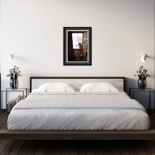 Modern bedroom with sober decoration with a framed print of Palazzo Pubblico, located in Piazza del Campo taken by Photographer Scott Allen Wilson in Siena, Italy.