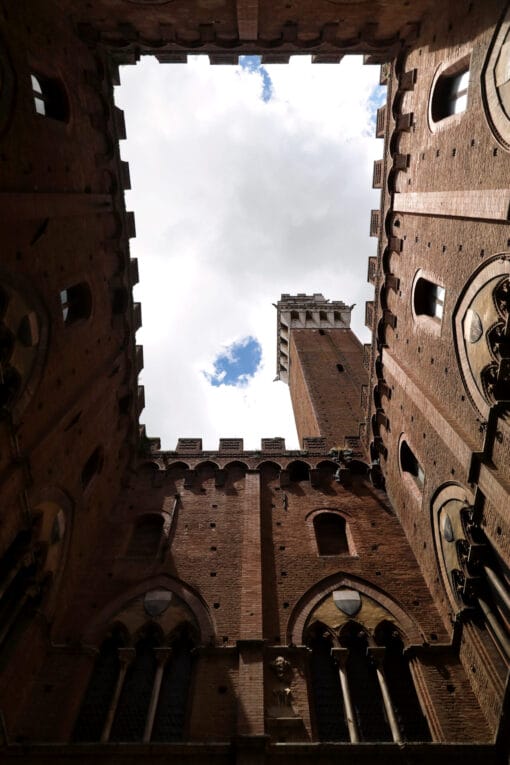 Amazing photo of the tall brick structure of Palazzo Pubblico, one of Siena’s richest cultural spaces taken by Photographer Scott Allen Wilson in Italy.