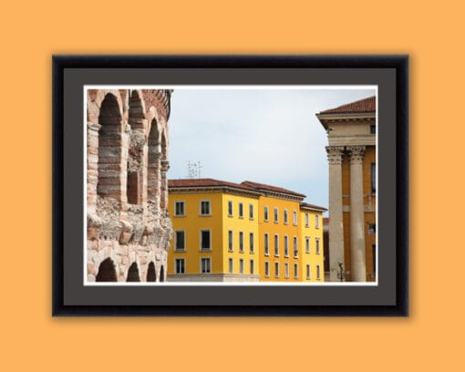 Colorful framed print of the Amphitheater of Verona, Italy next to a bright yellow building taken by Photographer Scott Allen Wilson.