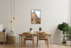 Minimalist wooden dining table decorated with a framed print of Castel Sant'Elmo captured in Naples, Italy by Photographer Scott Allen Wilson