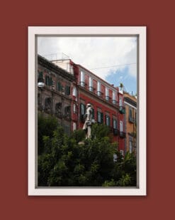 Elegant white framed print of the colorful buildings behind the bushes of Piazza Bellini located in Naples, Italy taken by Photographer Scott Allen Wilson