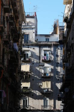 Architecture print captured by Photographer Scott Allen Wilson of a residential building framed by a narrow street in Naples, Italy.