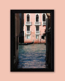Framed print of Venice, Italy with a pink building in the background and a gondoliere coming out from the left by Photographer Scott Allen Wilson.