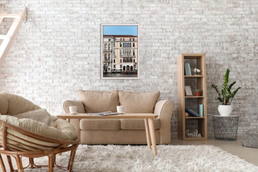 Cozy beige living room with a framed print over brick wall portraying Venice, Italy by Photographer Scott Allen Wilson.
