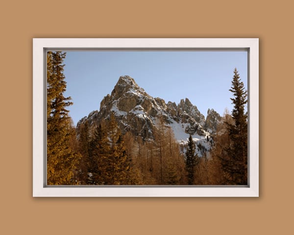 White framed print of mountain peaks of the Dolomites, Italy surrounded by reddish trees, taken by Photographer Scott Allen Wilson