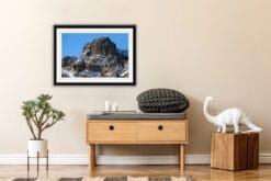 Minimalist shelf decoration with a framed print of the rocky mountain range of the Dolomites, Italy taken by Photographer Scott Allen Wilson