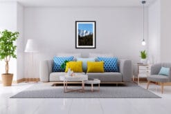 Modern gray living room with blue and yellow cushions and a print of the Dolomites' snow-capped mountains taken by Photographer Scott Allen Wilson.