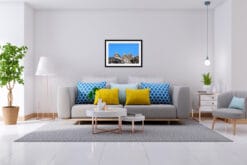 Modern gray living room with blue and yellow cushions and a print of the Dolomites' mountains peaks taken by Photographer Scott Allen Wilson.