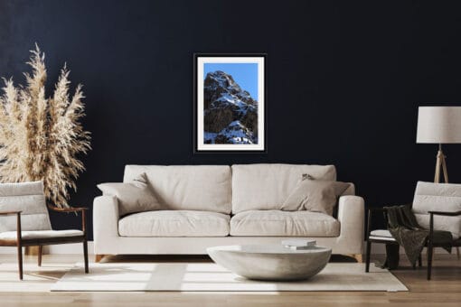 Classy and sober living room decoration with navy blue wall and a framed print of the Dolomites Italy taken by Photographer Scott Allen Wilson.