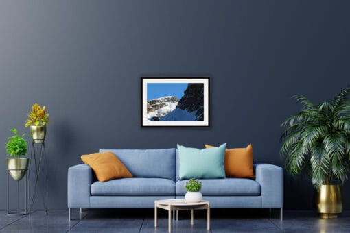 Blue living room decoration with a nature framed print of two jagged peaks of the Dolomites, Italy with an intense blue sky in the background taken by Photographer Scott Allen Wilson.