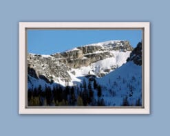 An amazing print of a jagged mountain of the Dolomites, Italy covered in snow and with a light blue sky in the background taken by Photographer Scott Allen Wilson.