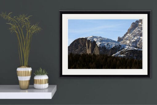 Minimalist decoration of a green wall with a beautiful landscape photo of the Dolomites, Italy and a pine tree forest below, taken by Photographer Scott Allen Wilson.