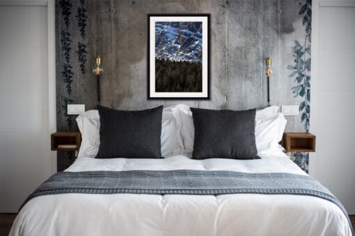 Sober bedroom decoration in navy blue tones with a classic framed print of the amazing texture of trees and the rocky mountains of the Dolomites, Italy taken by Photographer Scott Allen Wilson.