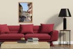 Modern living room decoration with a red sofa and a framed print of Lazise, Italy taken by Photographer Scott Allen Wilson.