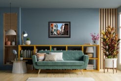 Cozy living room decoration with a blue wall and a framed photo of the colorful buildings in Peschiera del Garda, Italy taken by Photographer Scott Allen Wilson.