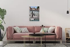 Pink living room decoration with a framed print of a traditional building at the edge of the water taken in Peschiera del Garda, Italy by Photographer Scott Allen Wilson.