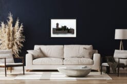 Sober living room design with a navy blue wall and classic framed print of Castello Scagliero in Lazise, Italy taken by Photographer Scott Allen Wilson.