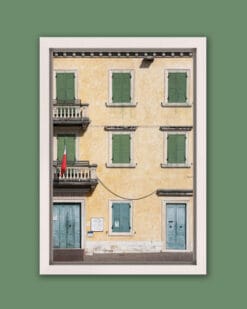 Framed print of a yellow building with symmetric green and blue window frames taken in Peschiera del Garda, Italy by Photographer Scott Allen Wilson.