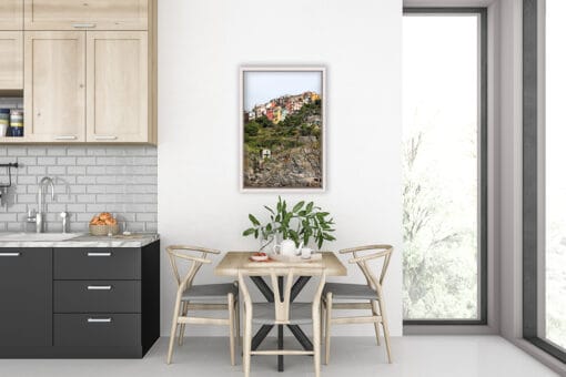 A print of Corniglia, Cinque Terre, on the wall of a wooden decorated kitchen. By Photographer Scott Allen Wilson.