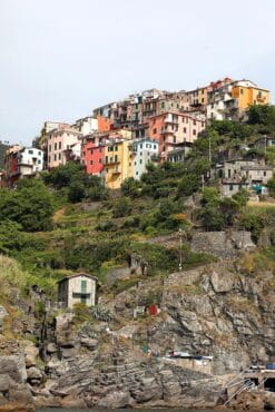 Corniglia, Cinque Terre, Italy: the greenery and colorful buildings on rocky hills. By Photographer Scott Allen Wilson.