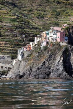 A view of Manarola in Cinque Terre, Italy, mounted up a peak over the sea. Captured by Photographer Scott Allen Wilson.
