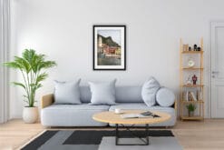 Print of Vernazza, Italy by Photographer Scott Allen Wilson hangs in a minimal living room with wooden decor.