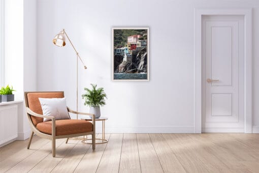 Photographer Scott Allen Wilson’s print of Vernazza, Cinque Terre, hangs in a minimal room with wooden flooring.