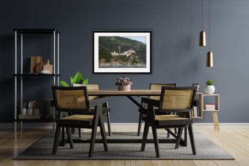 A print of Corniglia in Cinque Terre, Italy, completes a modern dining room with wooden details Created by Photographer Scott Allen Wilson.