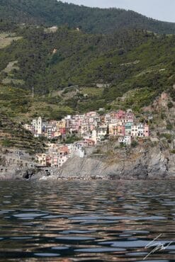 A balanced view of Manarola in Cinque Terre, Italy, encapsulated by the hills and the sea. By Photographer Scott Allen Wilson.