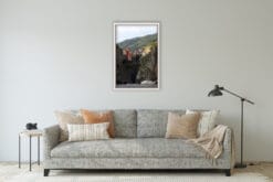 The grey and warm toned living room is complimented by Photographer Scott Allen Wilson’s print of Cinque Terre, Italy.