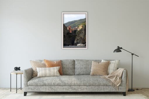 The grey and warm toned living room is complimented by Photographer Scott Allen Wilson’s print of Cinque Terre, Italy.