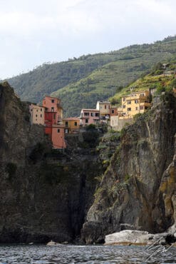 Clinging to the rocks and overhanging the sea, are the small villages that make up Cinque Terre, Italy. Shot by Photographer Scott Allen Wilson.