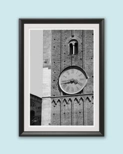 Black framed black and white print of a detail of the clock tower of Palazzo del Governatore. Captured by Scott Allen Wilson