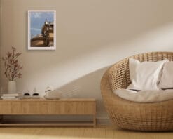 A print of the Basilica of Parma hung in a beige room with wooden decor. By Photographer Scott Allen Wilson.